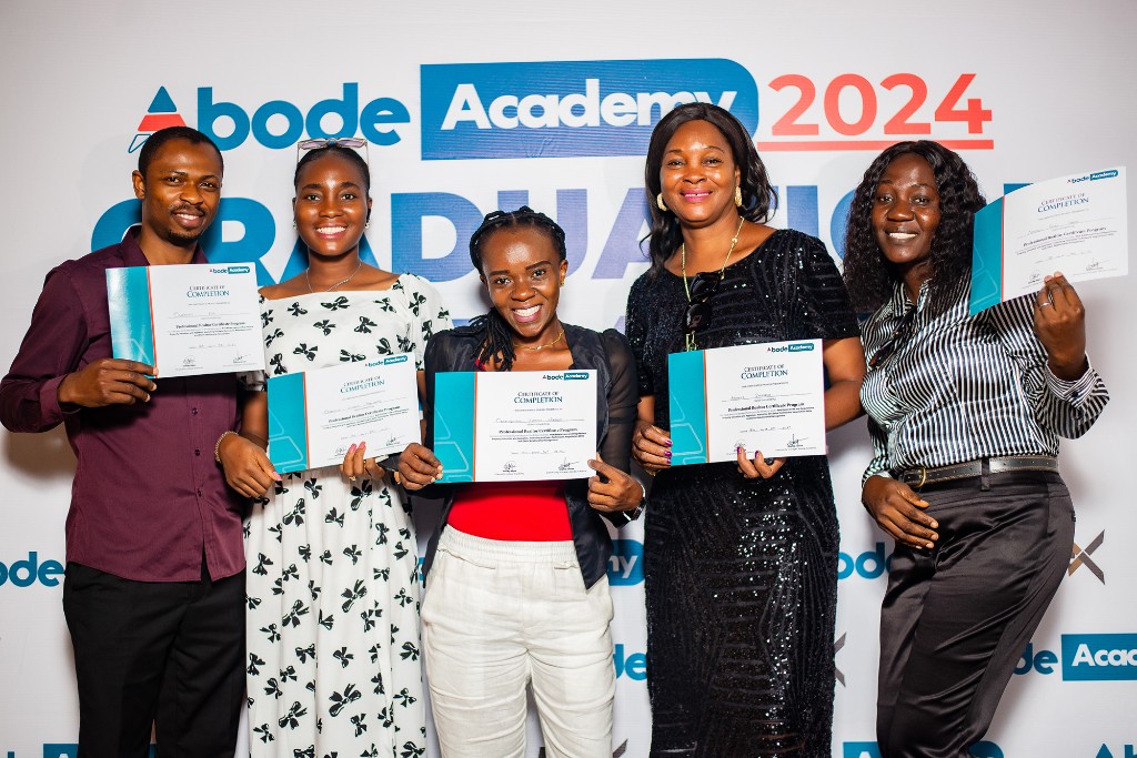 Associates celebrating with certificates