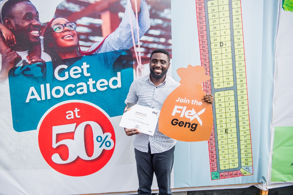Flex customer holding a Certificate of Ownership at a Flex event